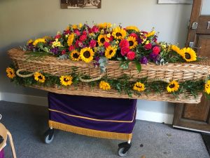 Eco-Friendly Coffin with floral tribute supplied by Albert Parr in Beckenham